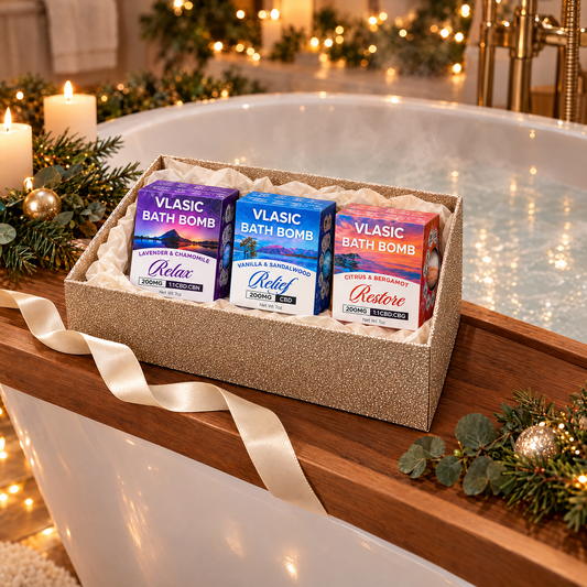 Bath Bomb Gift Set in a gold glitter gift box on a bath tray